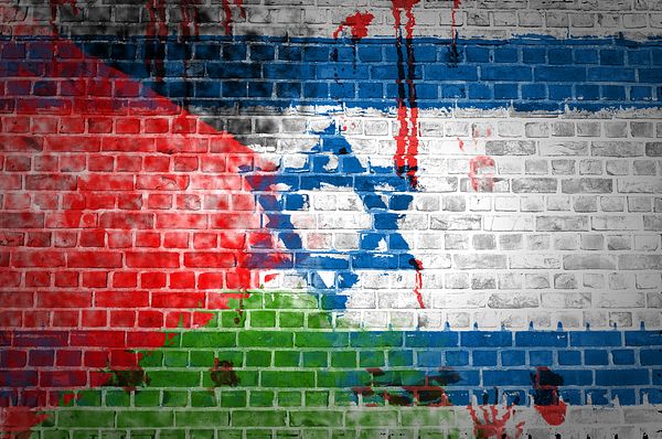 israeli flag with blood representing tensions rising in Gaza and the West Bank